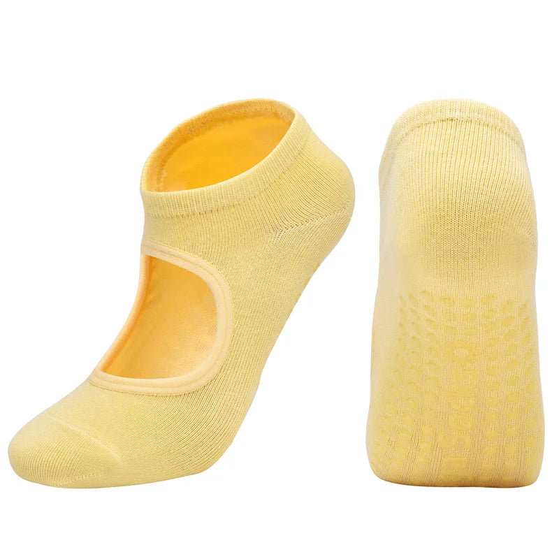A pair of yellow breathable women's Pilates and yoga socks shown from the side.