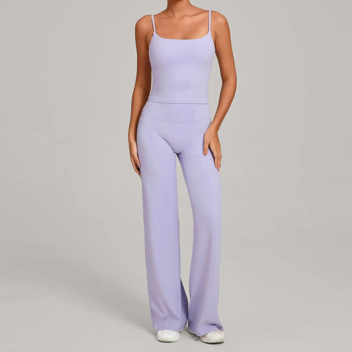A woman wearing a light purple high-waist yoga and fitness tracksuit set.