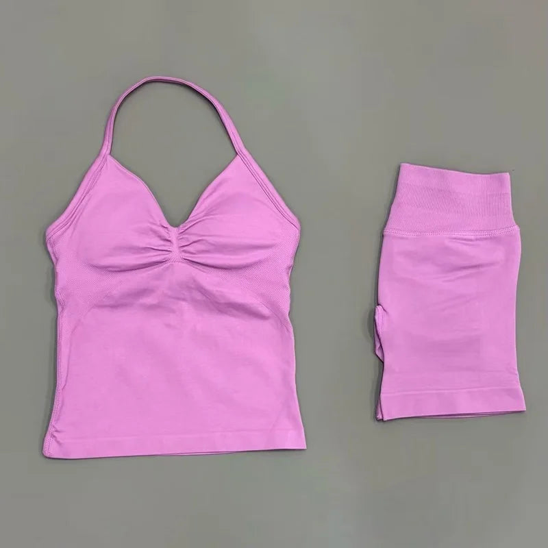 A bright pink women's seamless fitness set consisting of a cropped top and a long-sleeved sports bra or shirt.