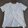 White women's breathable summer yoga and fitness t-shirt folded on a dark surface.