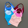 A collection of five seamless performance yoga and gym tank tops in various colors including blue, white, pink, red, and cora