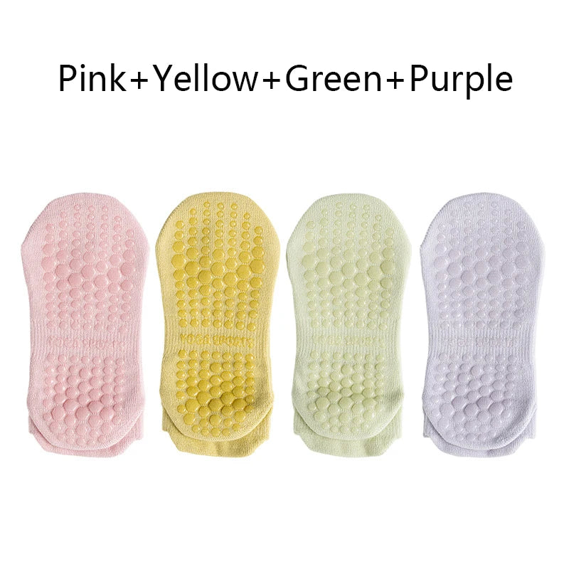A pack of four non-slip yoga socks in pink, yellow, green, and purple colors.