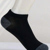 Black and gray ankle socks displayed on a white mannequin leg.