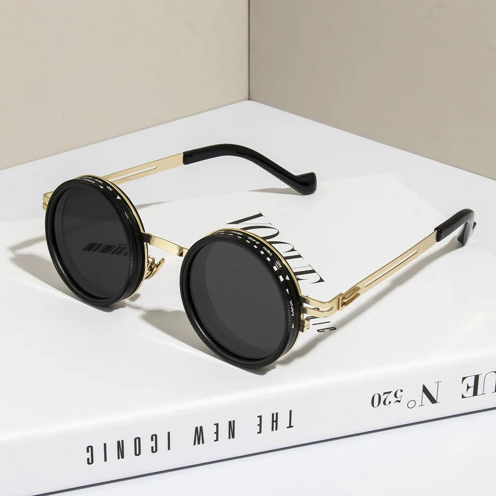 Gold-toned polarized round sunglasses with black lenses and silver accents displayed on a white box.