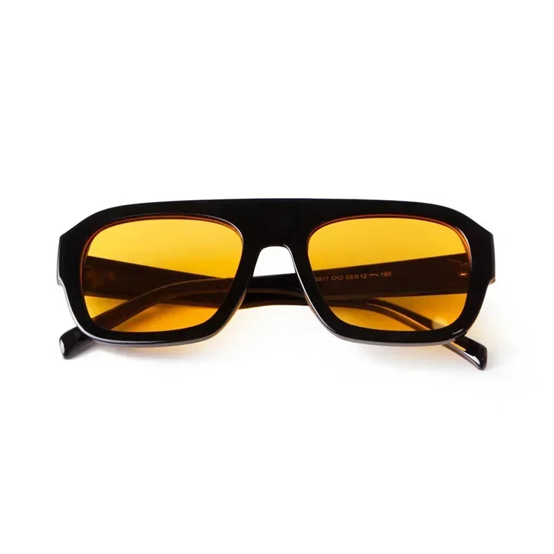 Vintage oversized square sunglasses with a dark brown tortoiseshell frame and amber lenses.