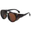 A pair of black leather retro steampunk goggles sunglasses with brown tinted lenses and brass accents.