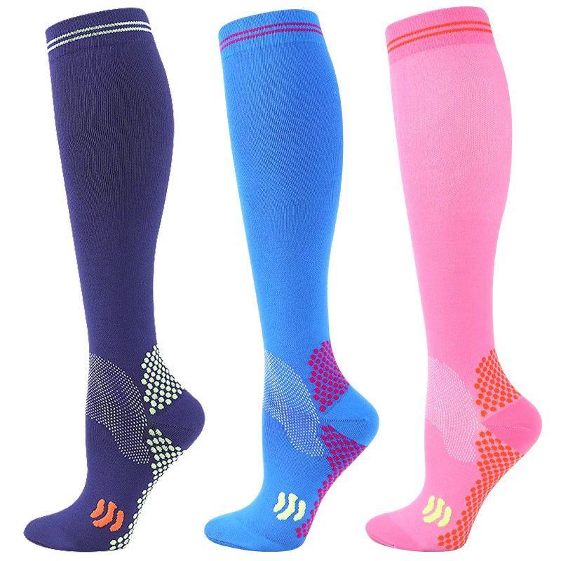 Three pairs of medical grade compression socks in navy blue, royal blue, and pink.