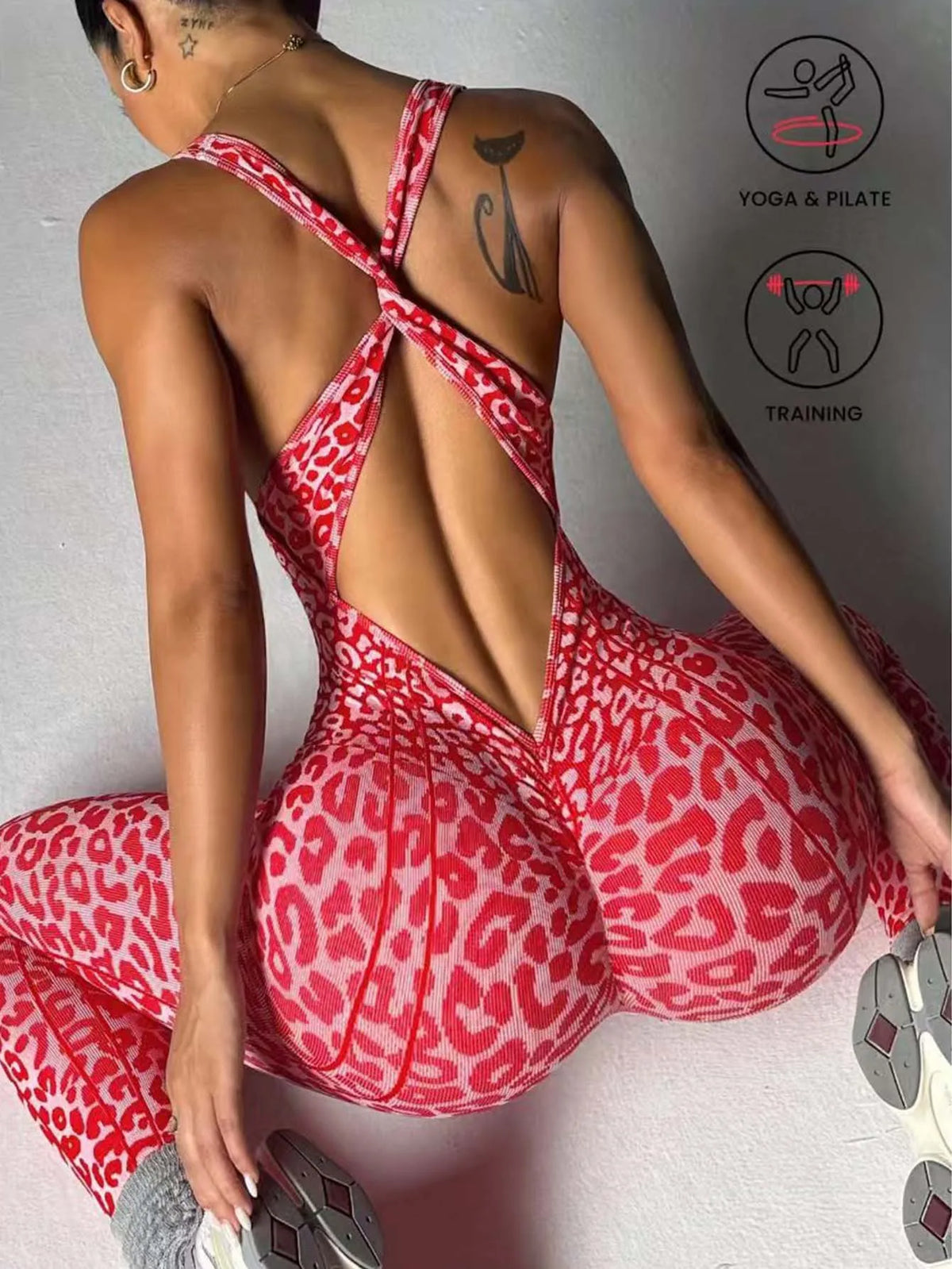 A woman wearing a red leopard print seamless yoga jumpsuit, shown from the back.