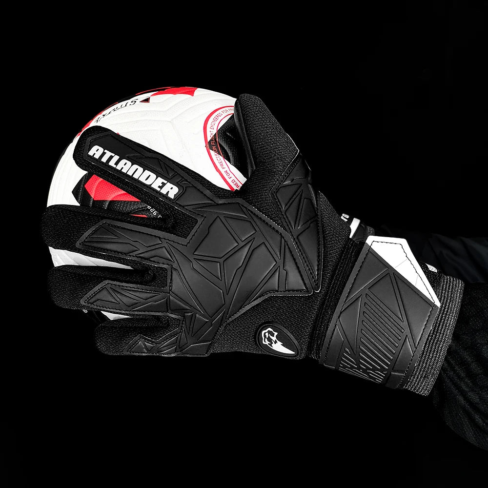Black and white latex goalkeeper gloves with a red and white soccer ball visible.