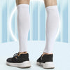 A person wearing white compression leg sleeves is shown, demonstrating the wrapping of muscles to reduce tremors.