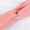 A soft coral pink bohemian chiffon headband tied in a knot, shown from the side.