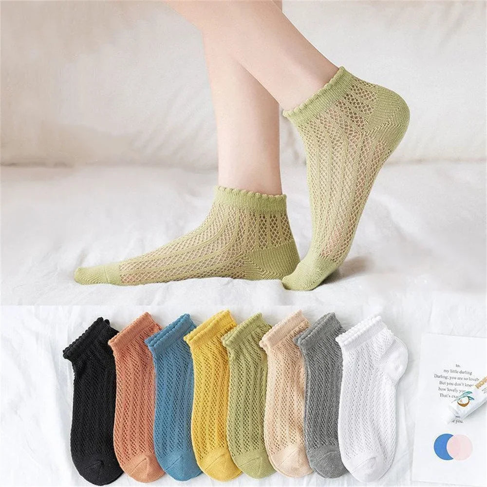 A collection of breathable mesh lace tube socks in various pastel and neutral colors displayed on a white surface.