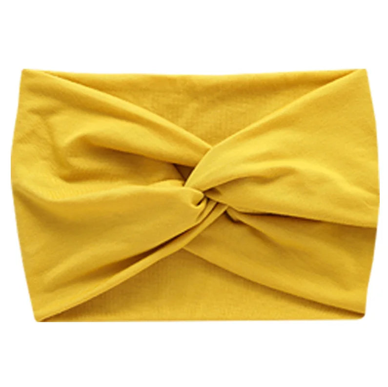 Yellow women's elastic sports headband folded and displayed