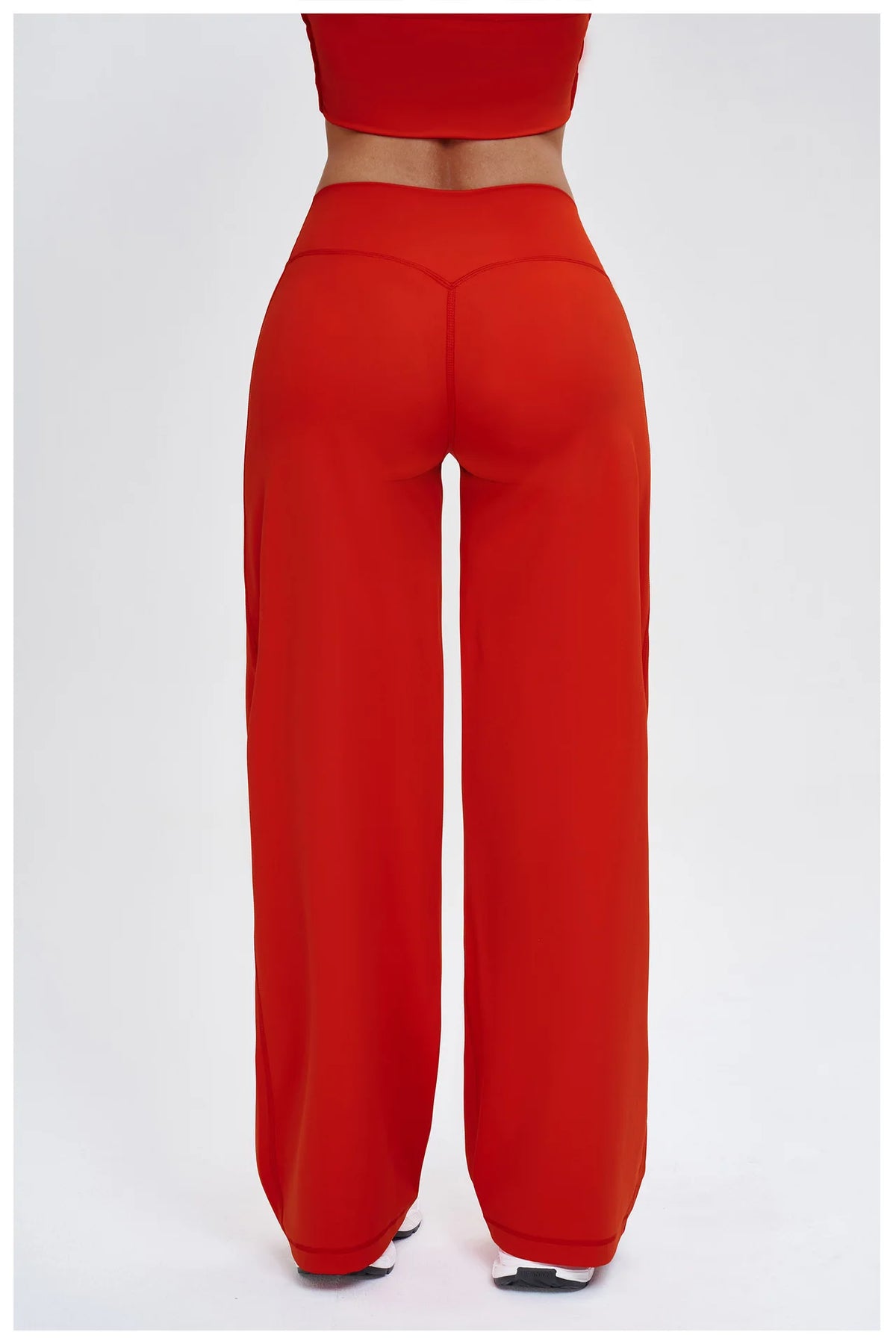 A model wearing red high-waist wide-leg yoga leggings.
