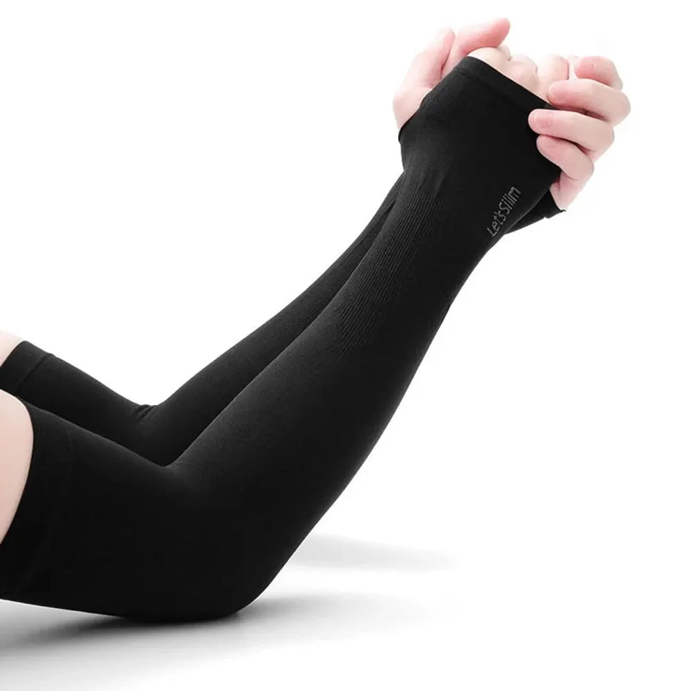 A hand is holding a black compression arm sleeve for sun and UV protection.