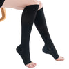 Black medical grade knee high compression stockings worn on a foot.