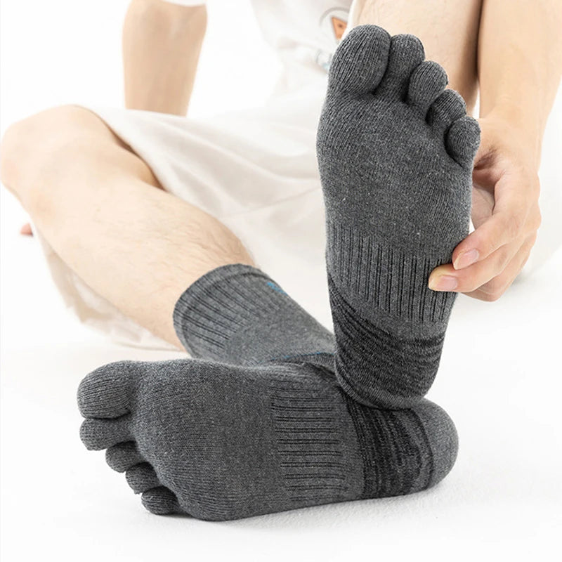 A pair of gray men's sport compression socks worn on a foot.