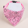 Pink paisley bandana with a white tag, designed as an adjustable pet scarf for dogs and kittens.