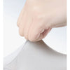 A hand wearing an elastic fit glove is shown pressing down on a white fabric surface.