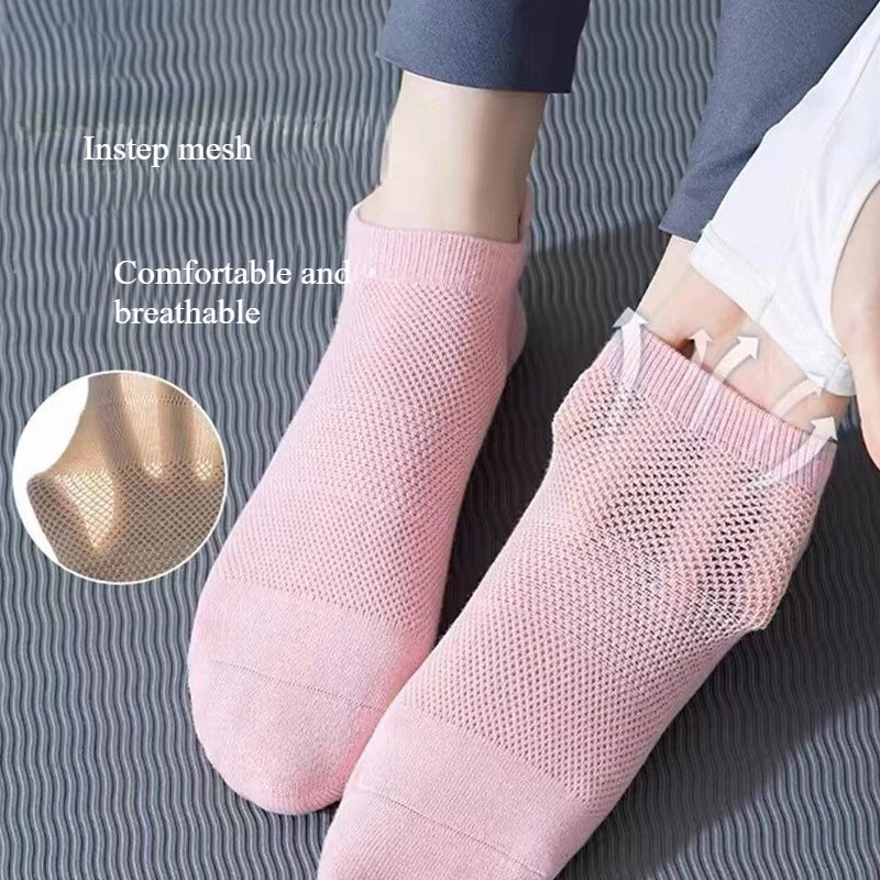 Chaussettes de yoga et fitness en maille respirante rose, portées sur un pied