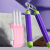 A pink carrot-shaped fidget toy with white fingers is shown next to a green silicone fidget tool.