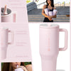A pink insulated stainless steel water bottle with a handle and flip straw shown in various contexts.