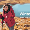 A woman wearing a red winter glove smiles while exploring outdoors in a sunny, rugged landscape.