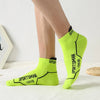 A pair of bright lime green athletic socks for men, shown on a leg.
