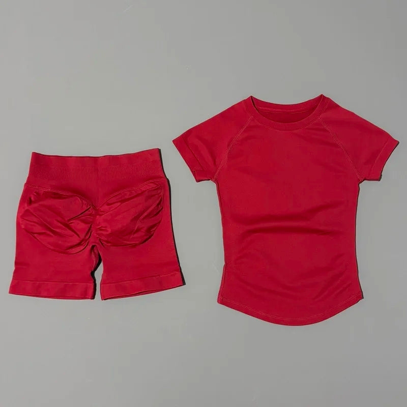 A bright red seamless yoga set for women featuring a short sleeve top and workout leggings.