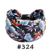 A black knotted cotton headband with a floral and leaf print in blue, purple, and orange tones.
