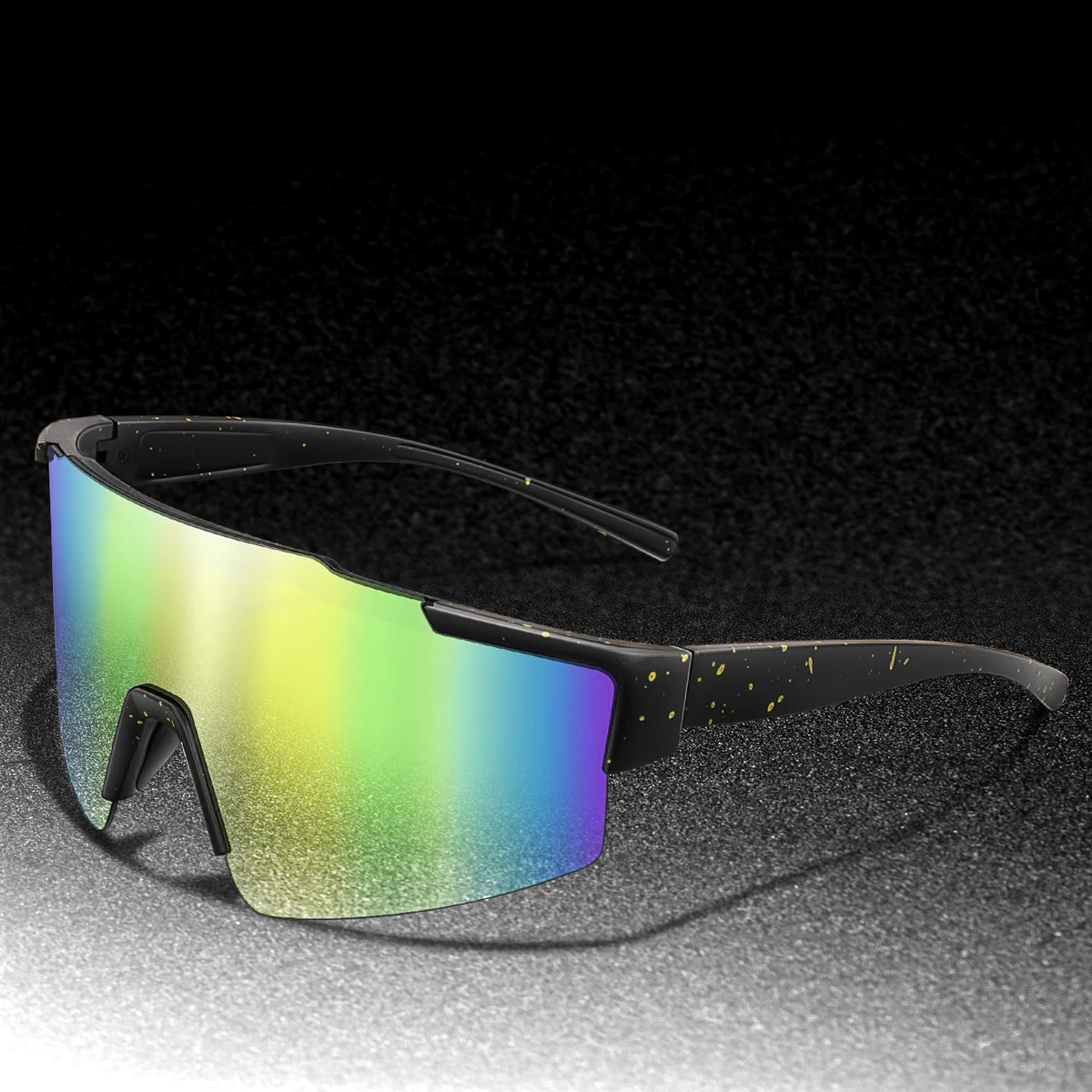 A pair of black cycling sunglasses with a multicolored, iridescent lens resting on a dark surface.
