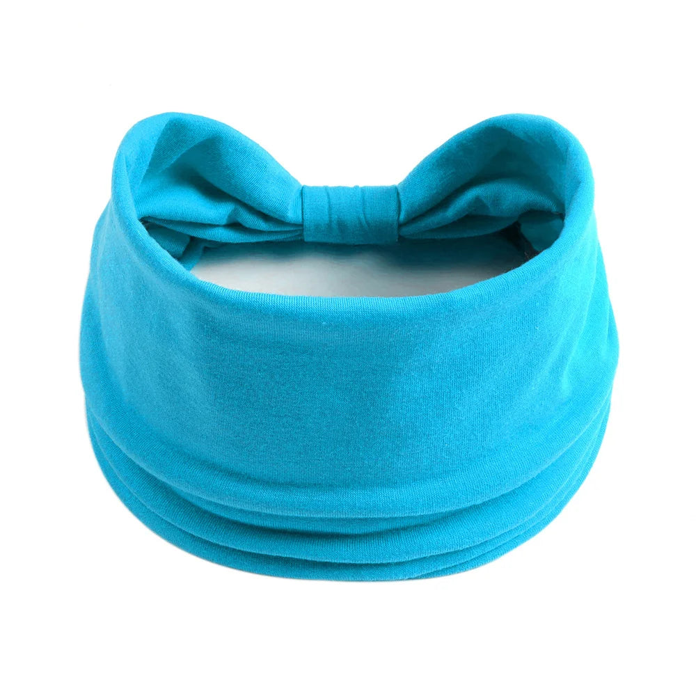 Un foulard de tissu turquoise vif noué en nœud, adapté pour les cheveux et le style.