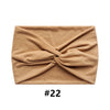 A beige boho wide turban headband folded into a knot.