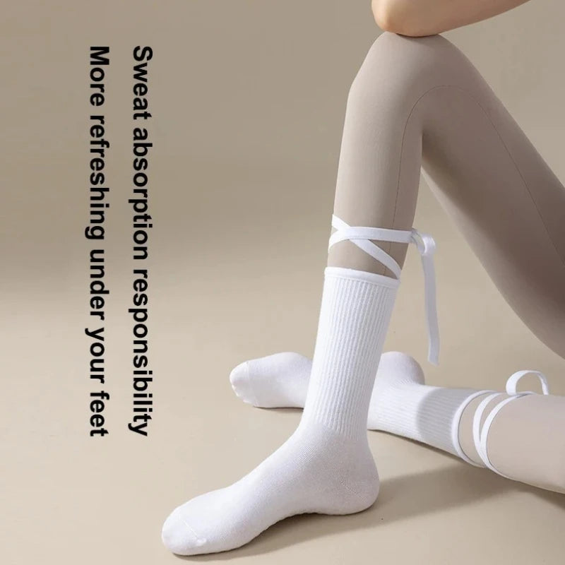 White silicone anti-slip yoga socks being worn on a foot and leg.