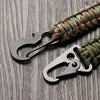 A close-up of a multi-tool keychain featuring a black scissor-style opener attached to a green and red braided cord.