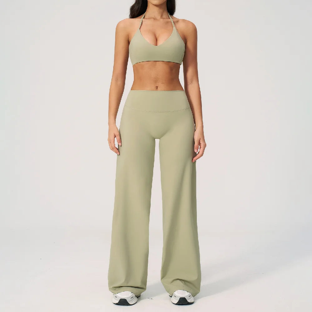 A woman wearing a light olive green women's premium fitness tracksuit top and matching pants.