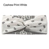 Diadema de tela blanca con estampado de anacardo negro, mostrada enrollada.