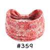 A close-up of a coral pink patterned boho knotted cotton headband.