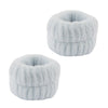 A pair of soft, fluffy white microfiber spa headband and wristband set.