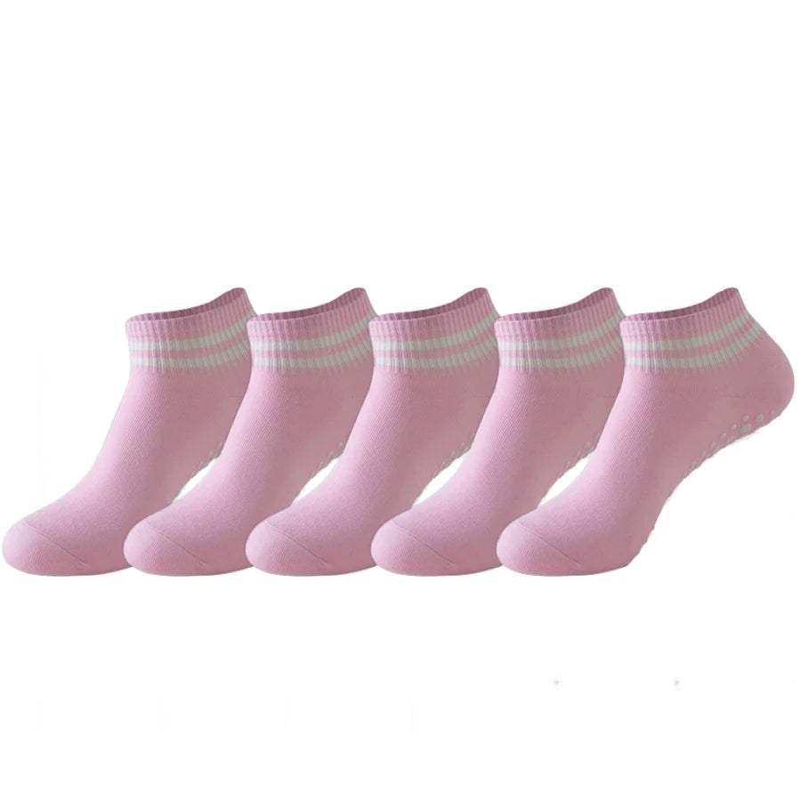 A set of pink non-slip grip socks for yoga and pilates