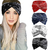 A woman models several extra wide boho headbands in red, navy blue, white, and black patterns.
