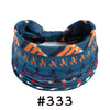 A blue patterned fabric headband tied in a bow, featuring orange and black geometric designs.