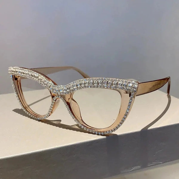 Gold-toned cat eye reading glasses with pave diamond detailing on the frame and temples.