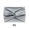 Gray fabric headband tied in a knot, shown flat lay.