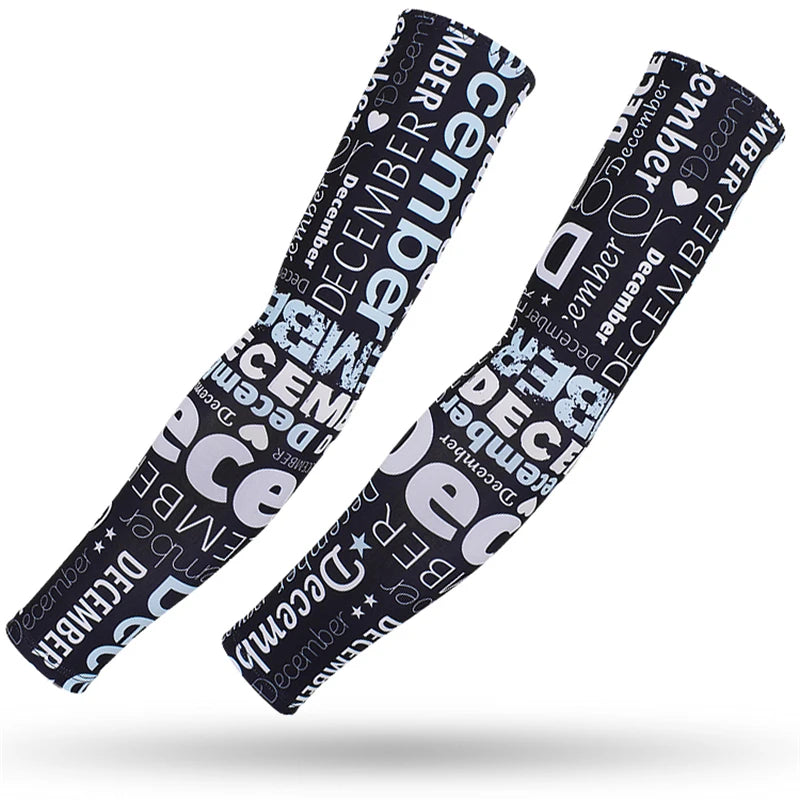 Two black and white patterned sports arm sleeves with December themed text