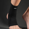 A black Vbasi ankle support brace is worn on a person's lower leg.