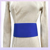 A close-up of a royal blue elastic band worn around the waist of a beige knitted garment.