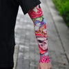 Close-up of a person's arm displaying colorful floral and skull tattoo sleeves for sun protection