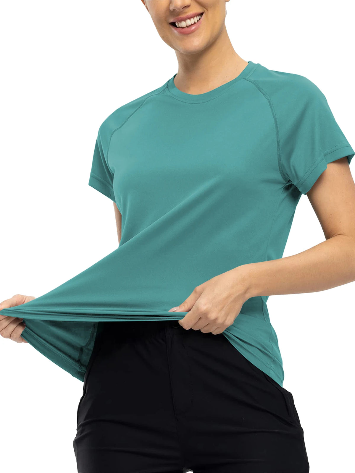 A woman wearing a teal quick dry moisture-wicking gym t-shirt and black pants.