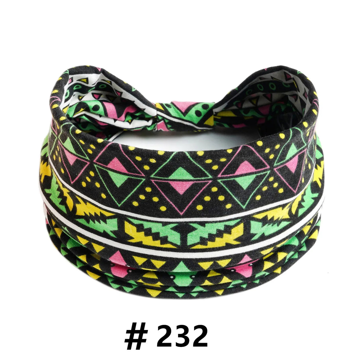 A black, pink, and green patterned boho cotton turban headband is shown flat.